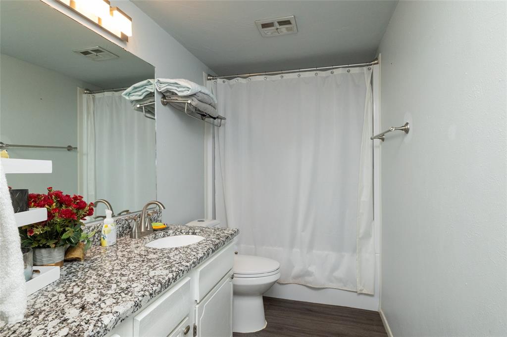 108 Harbor Drive, Unit 204 Runaway Bay, TX 76426 - Photo 18 of 22 a bathroom with a granite countertop sink toilet and shower