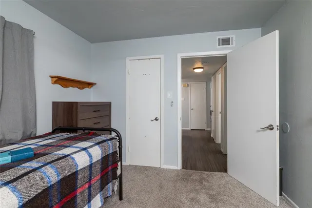 a bedroom with a bed and a painting on the wall