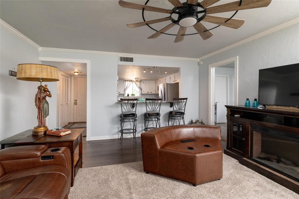 108 Harbor Drive, Unit 204 Runaway Bay, TX 76426 - Photo 8 of 22 a living room with furniture and a flat screen tv