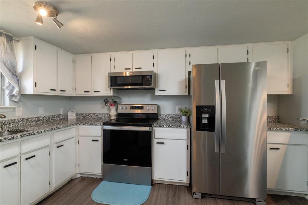 108 Harbor Drive, Unit 204 Runaway Bay, TX 76426 - Photo 10 of 22 a kitchen with stainless steel appliances a refrigerator stove and sink