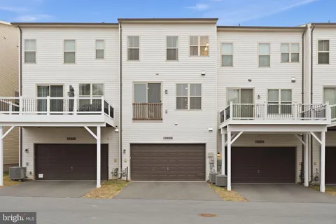 a front view of a house with a parking space