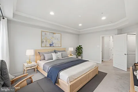 a bedroom with a large bed and a couch