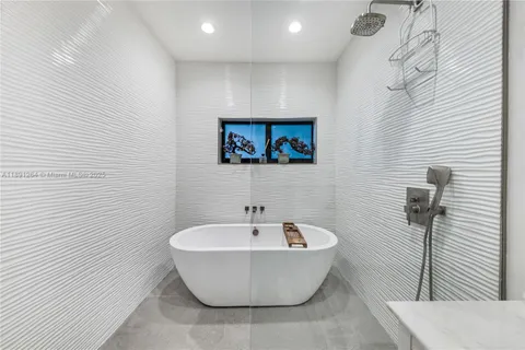 a bathroom with a bathtub and shower