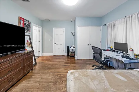 a bedroom with furniture and a flat screen tv