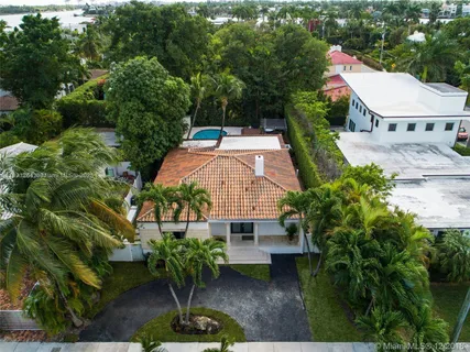 an aerial view of a house with garden space and sitting area