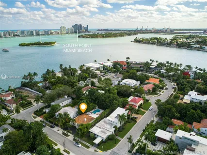 an aerial view of a houses with outdoor space and lake view