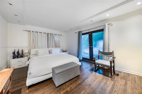 a bed room with a bed and a chair