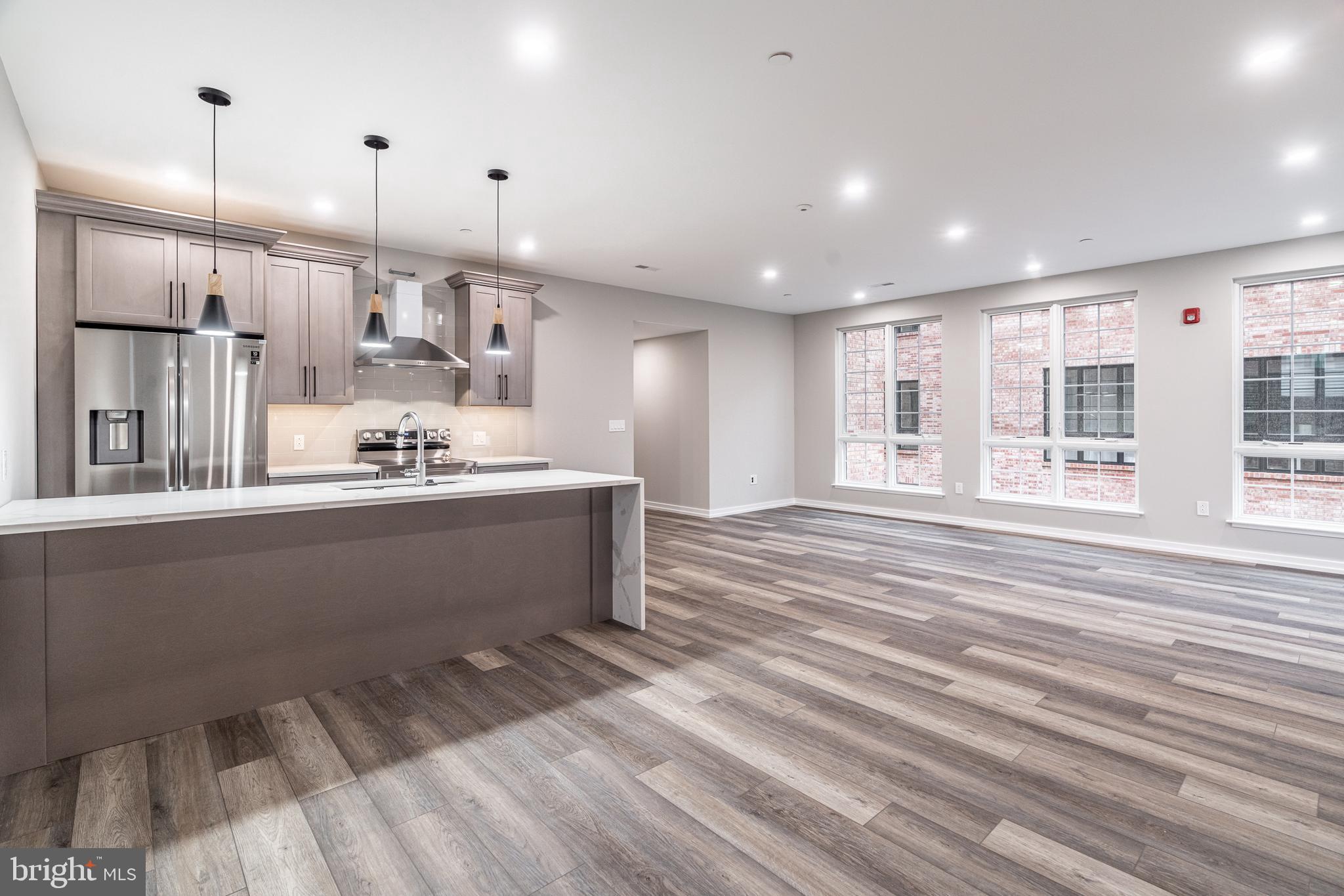 2412 Innovator Way, Unit 3 Philadelphia, PA 19146 - Photo 6 of 25 a large kitchen with stainless steel appliances kitchen island a large counter top a stove and a refrigerator