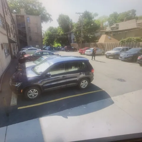 a view of a street with a car parked on the road