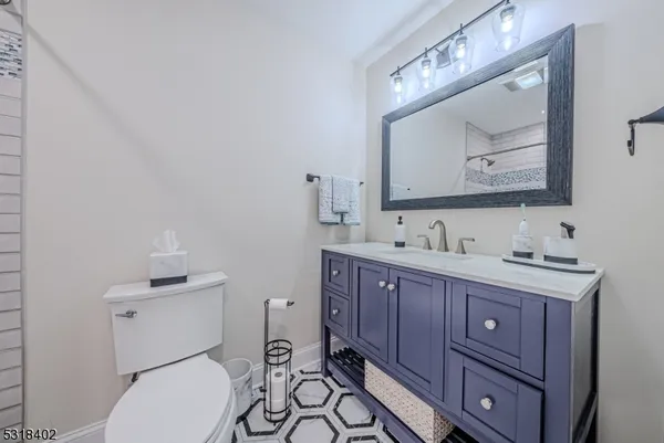 a bathroom with a toilet a sink and mirror