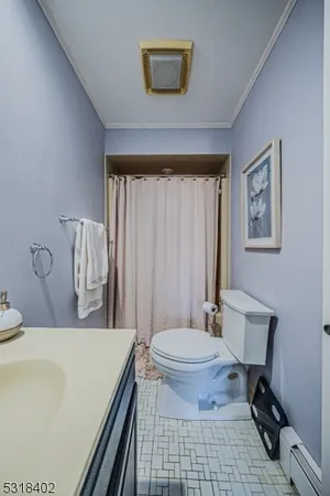 a bathroom with a sink toilet and a mirror