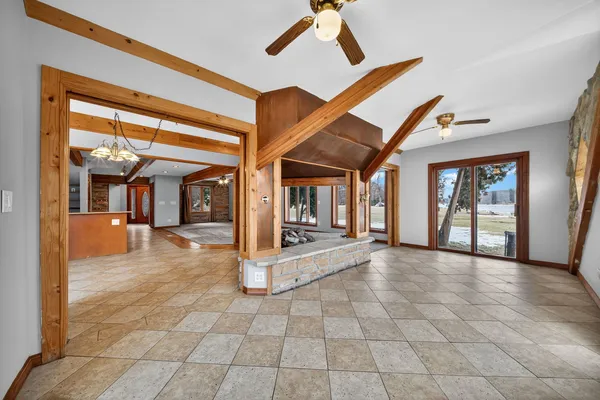 a kitchen with stainless steel appliances granite countertop a refrigerator a stove a sink dishwasher and wooden cabinets with a large window