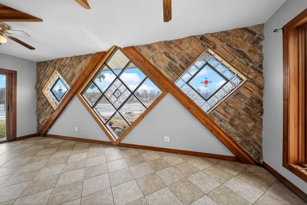 a kitchen with stainless steel appliances granite countertop a sink and a large window