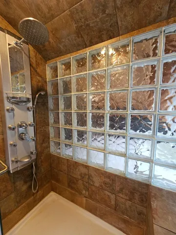 a view of a bathroom with a tub and door
