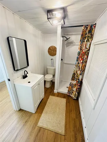 a bathroom with a sink a mirror and shower