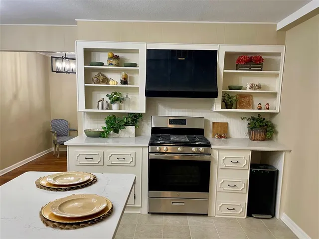 a kitchen with a stove and a microwave