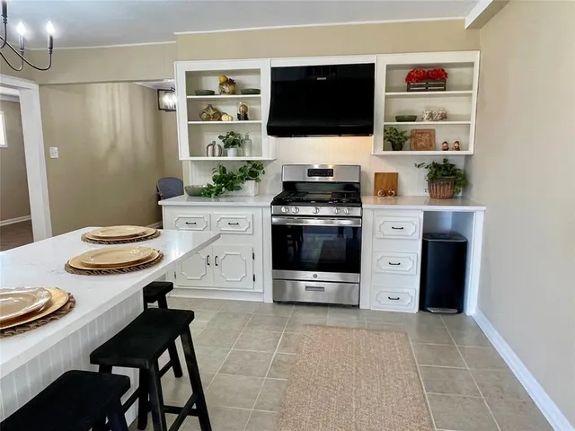 a kitchen with stainless steel appliances a stove a sink and a refrigerator