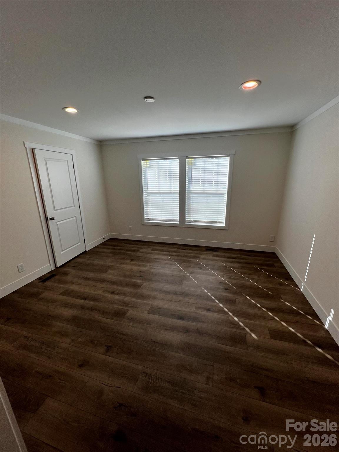111 Overcash Road Troutman, NC 28166 - Photo 14 of 19 an empty room with wooden floor and windows