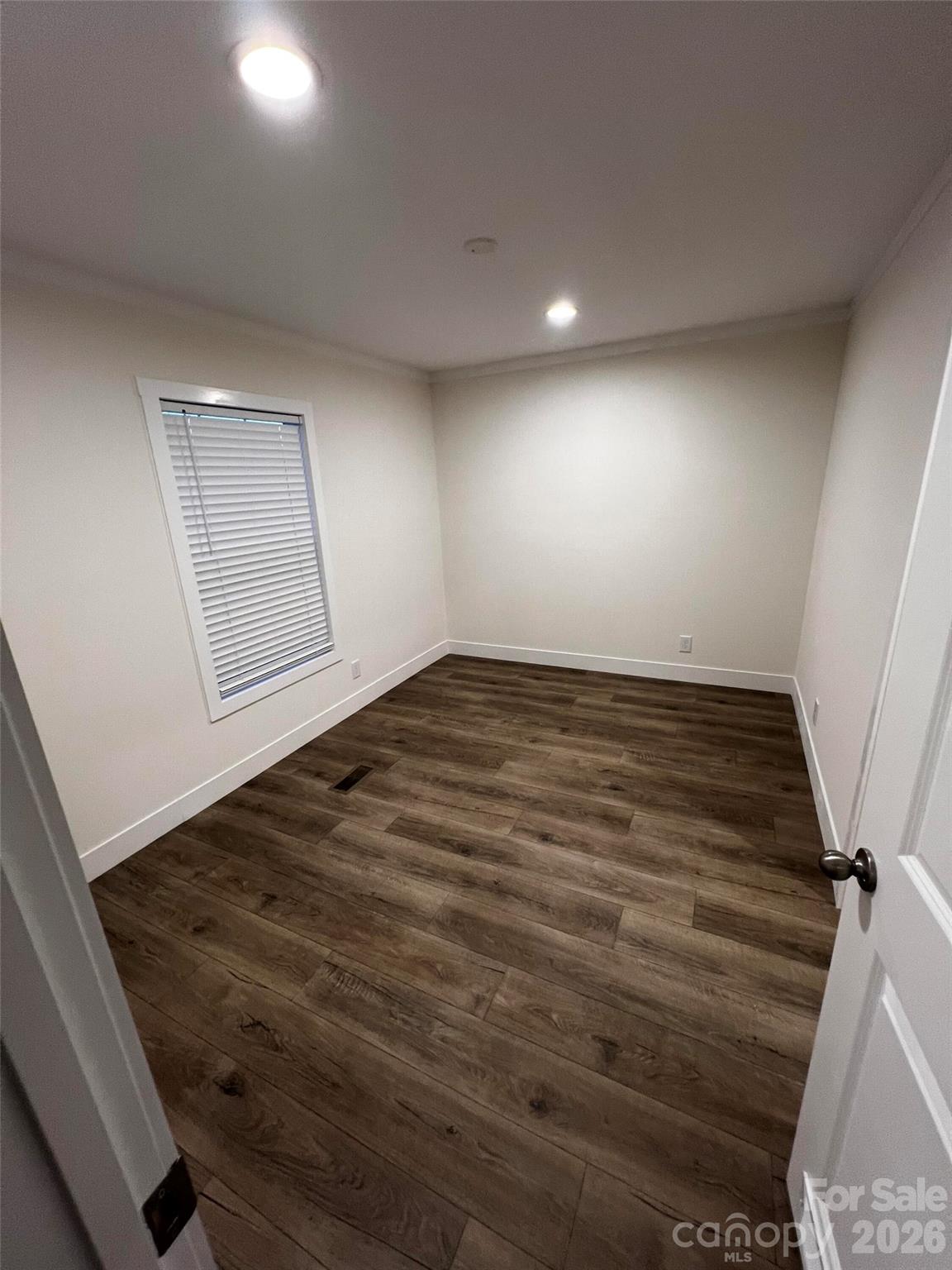 111 Overcash Road Troutman, NC 28166 - Photo 18 of 19 an empty room with wooden floor and windows