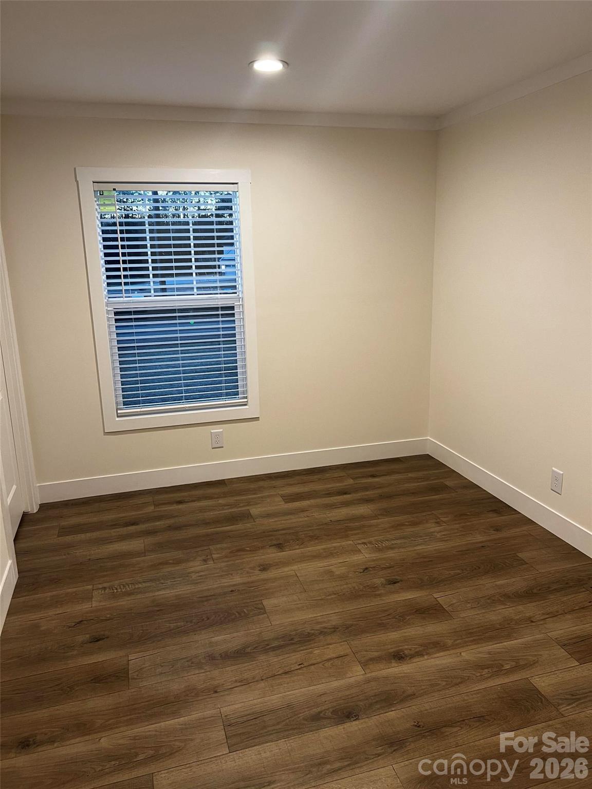 111 Overcash Road Troutman, NC 28166 - Photo 19 of 19 a view of an empty room with wooden floor and a window