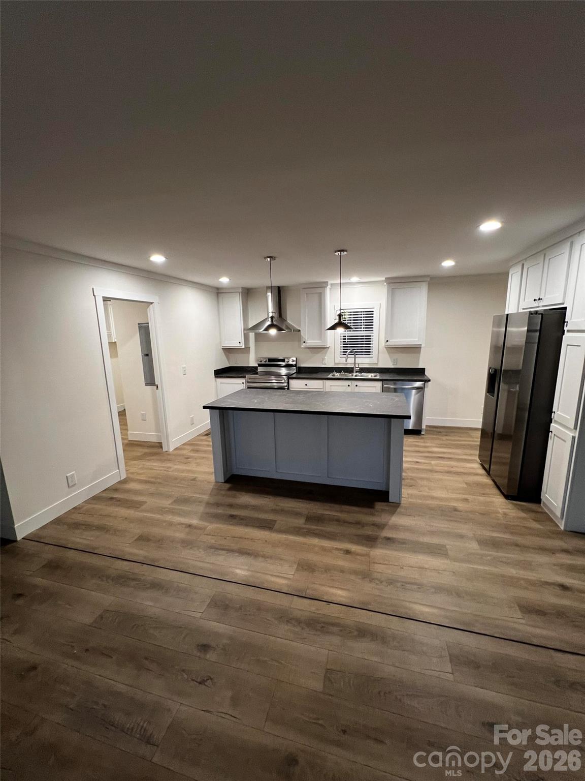 111 Overcash Road Troutman, NC 28166 - Photo 5 of 19 a large kitchen with stainless steel appliances granite countertop a stove and a refrigerator