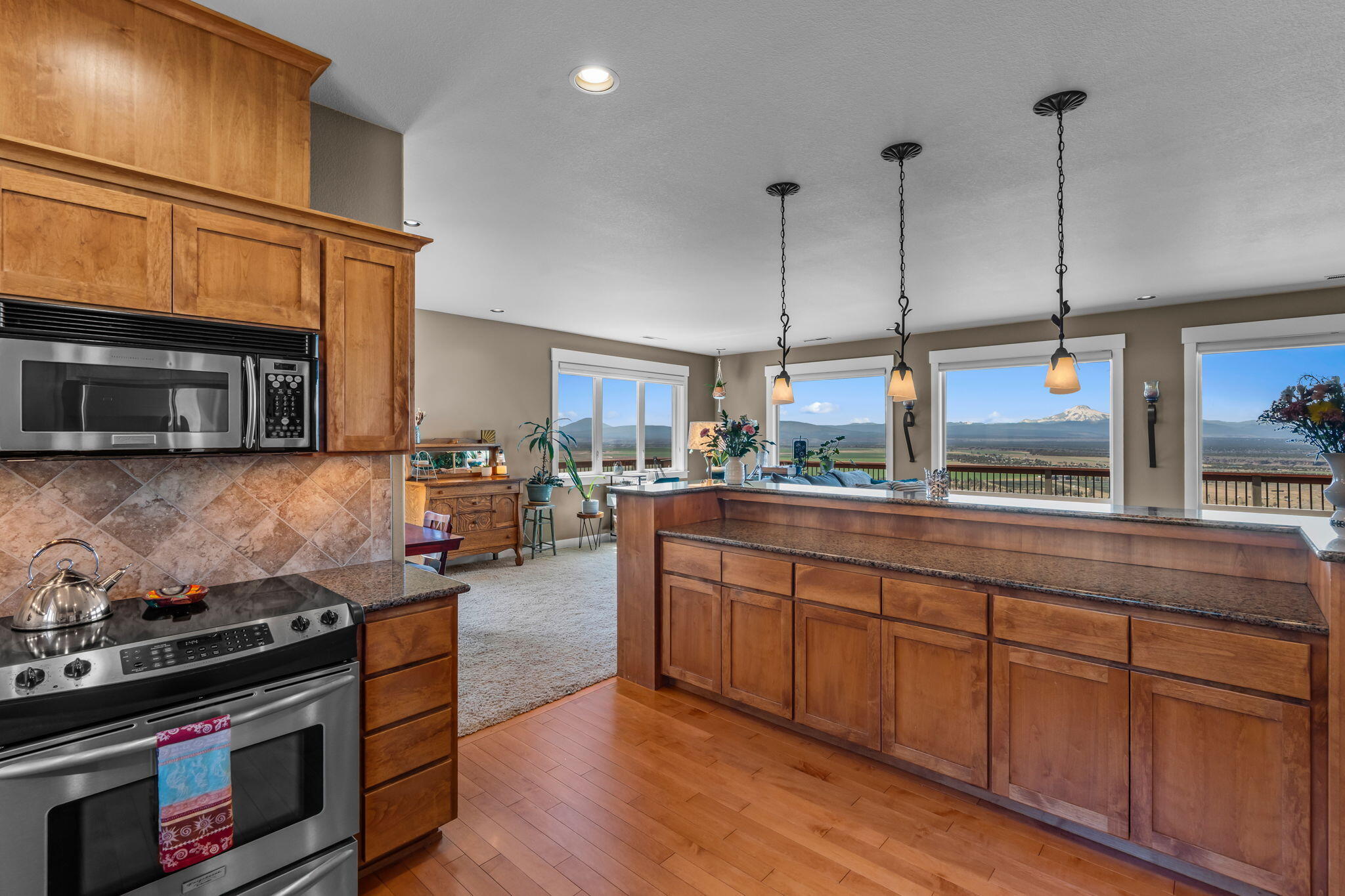 10875 Southwest Mintken Lane Culver, OR 97734 - Photo 2 of 43 a kitchen with stainless steel appliances granite countertop a stove a sink and a microwave