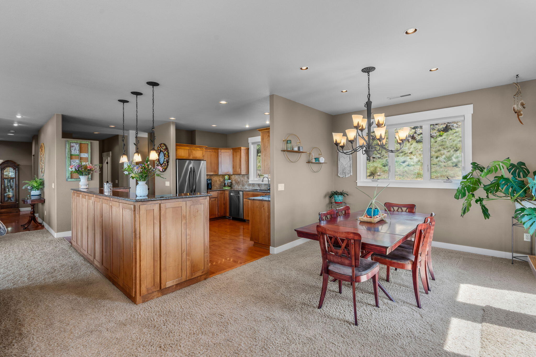 10875 Southwest Mintken Lane Culver, OR 97734 - Photo 5 of 43 a view of a dining room and livingroom with furniture wooden floor a chandelier
