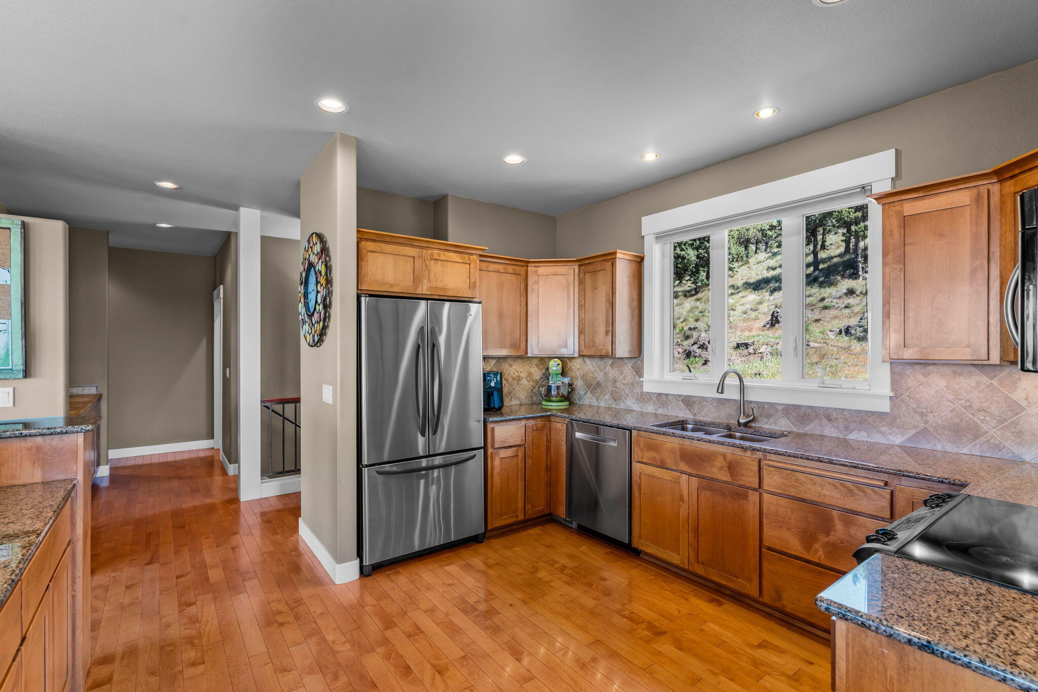 10875 Southwest Mintken Lane Culver, OR 97734 - Photo 6 of 43 a kitchen with stainless steel appliances granite countertop a refrigerator a sink a stove and island