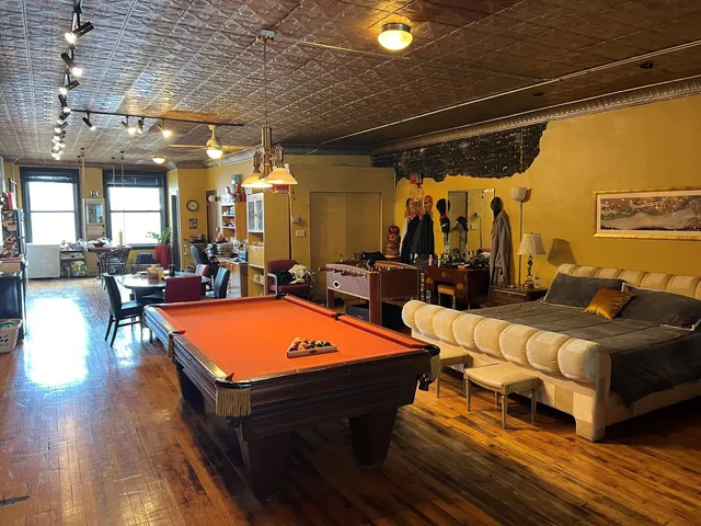 a living room with furniture a rug and a chandelier