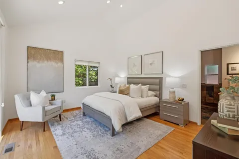 a bedroom with a bed and a couch