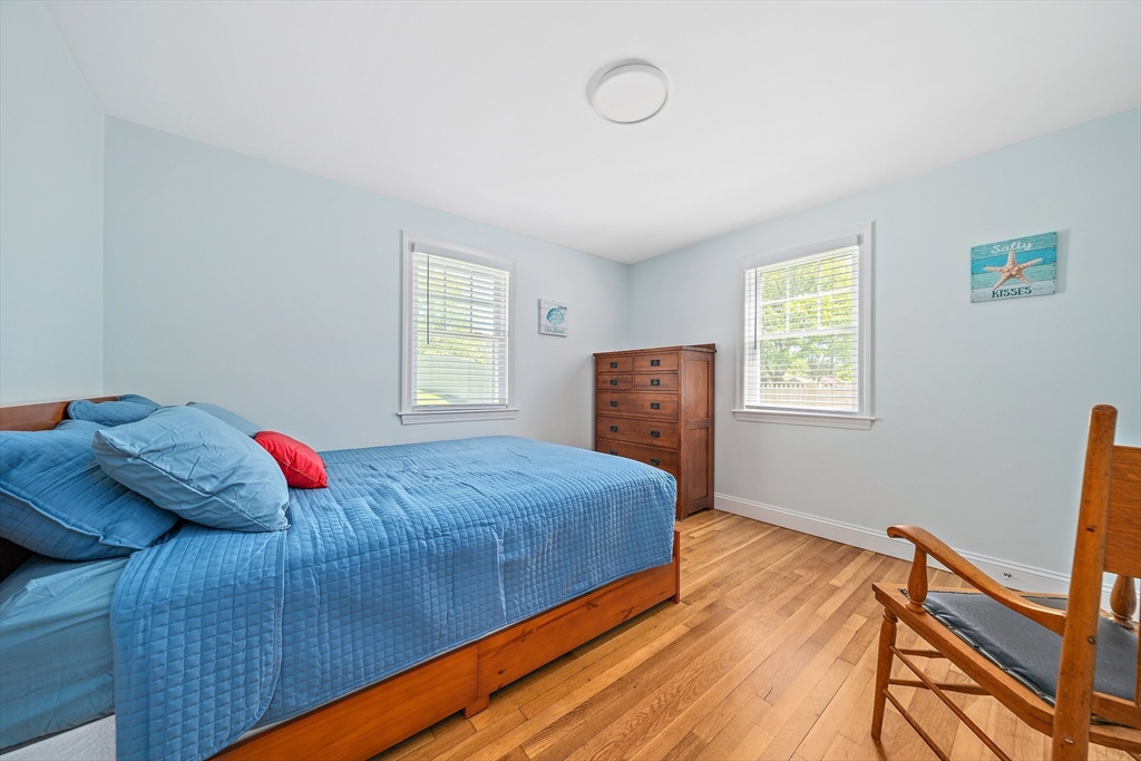 102 Cornell Drive Dennis, MA 02639 - Photo 20 of 37 a bedroom with a bed and wooden floor