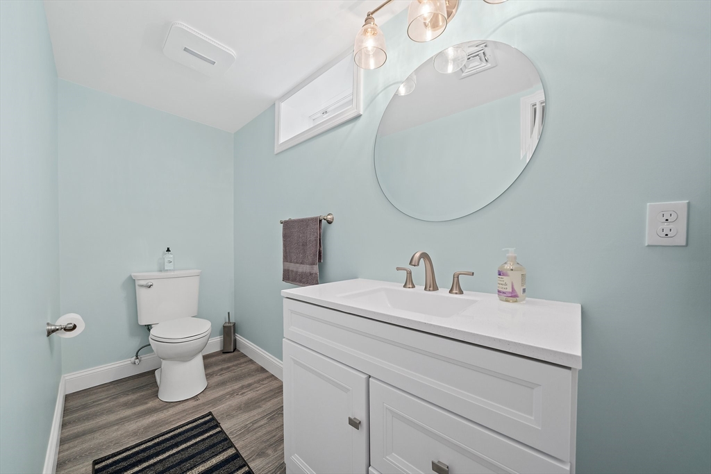 102 Cornell Drive Dennis, MA 02639 - Photo 27 of 37 a bathroom with a sink a toilet and a mirror