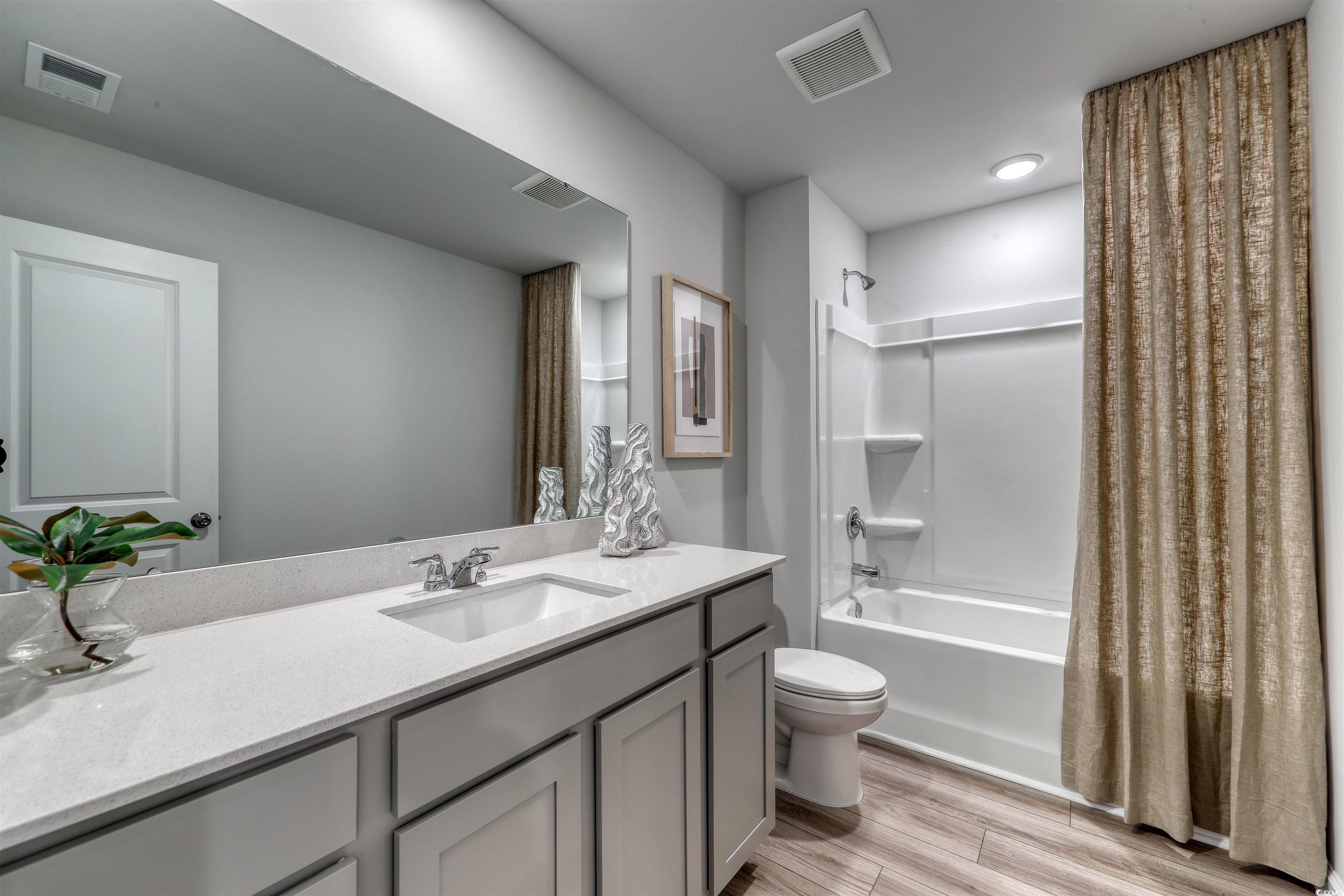 3090 Visionary Drive Myrtle Beach, SC 29588 - Photo 18 of 28 Full bathroom with shower / tub combo, vanity, and light wood-type flooring