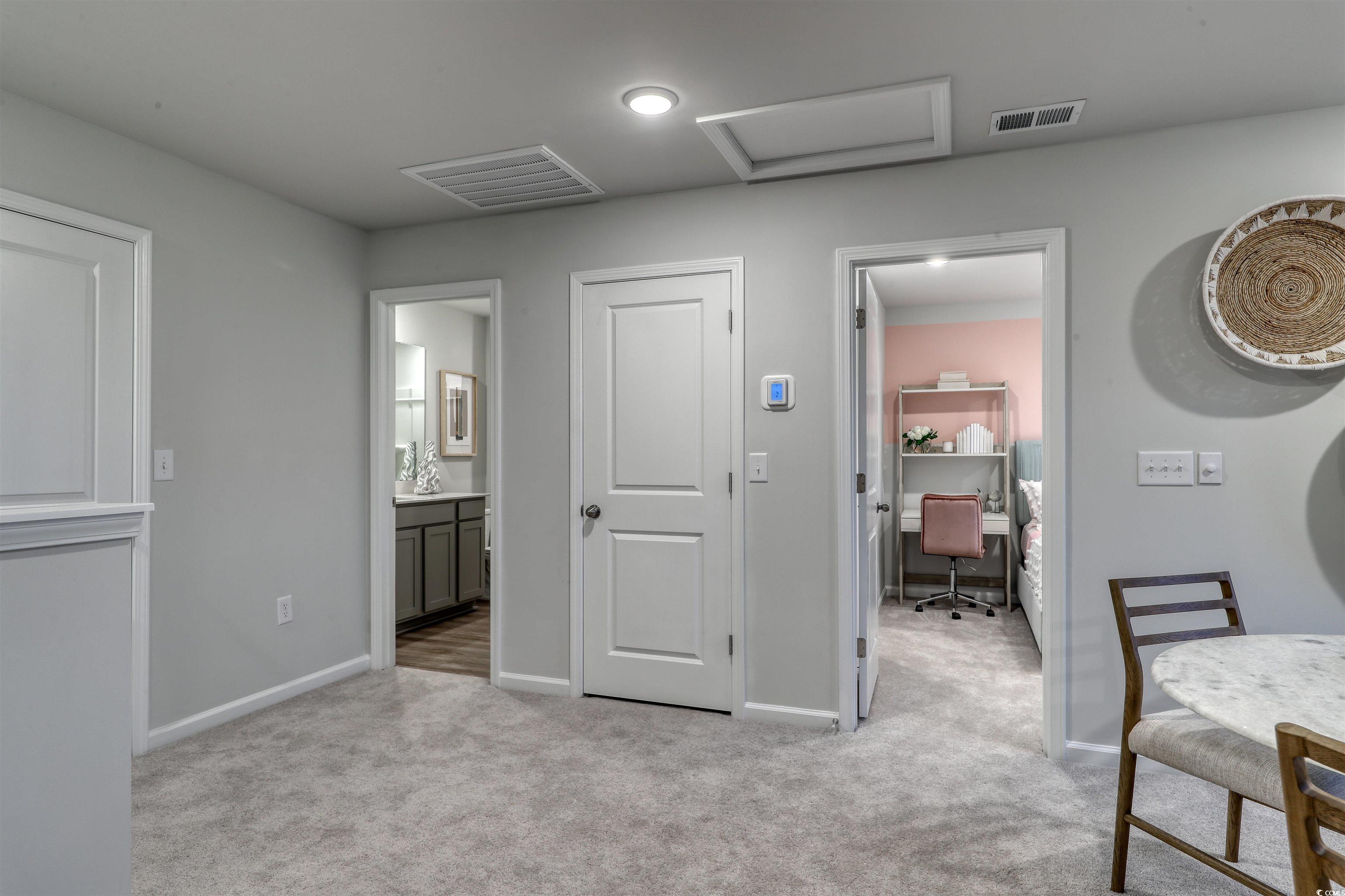 3090 Visionary Drive Myrtle Beach, SC 29588 - Photo 21 of 28 Bedroom with a desk, ensuite bathroom, attic access, and light carpet
