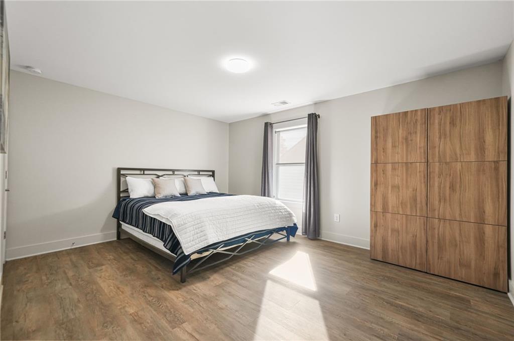 265 Holland Road Powder Springs, GA 30127 - Photo 17 of 27 a bed sitting in a spacious bedroom next to a window and a bathroom