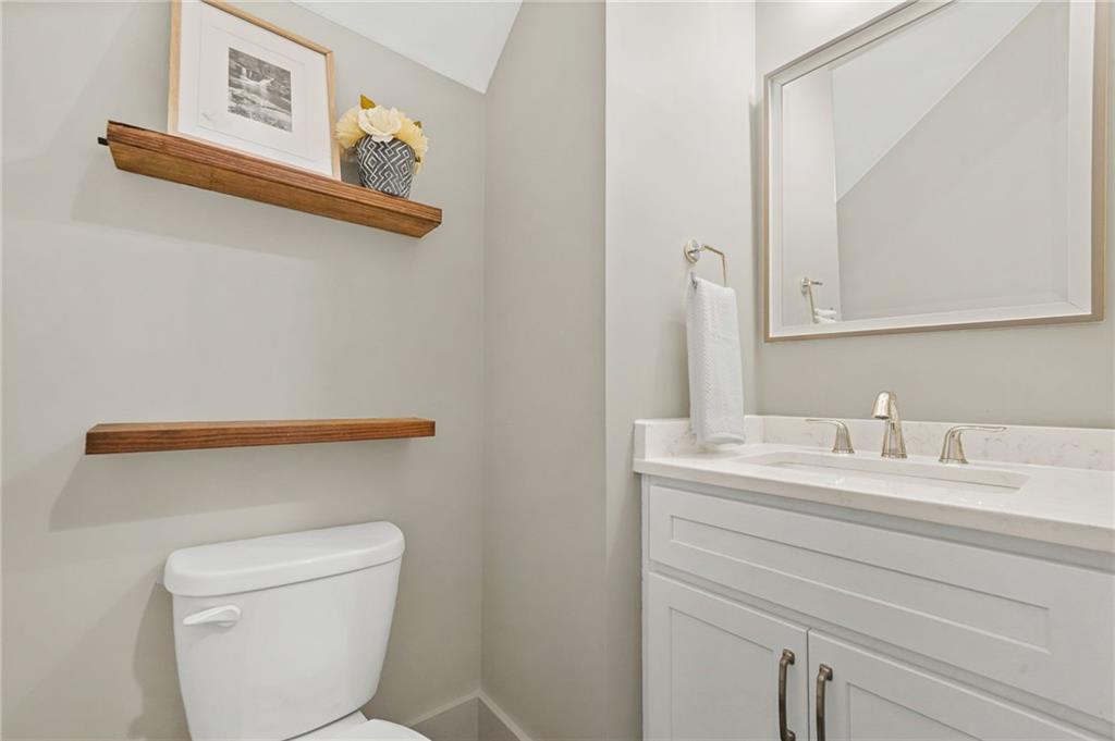 265 Holland Road Powder Springs, GA 30127 - Photo 22 of 27 a bathroom with a toilet sink and mirror
