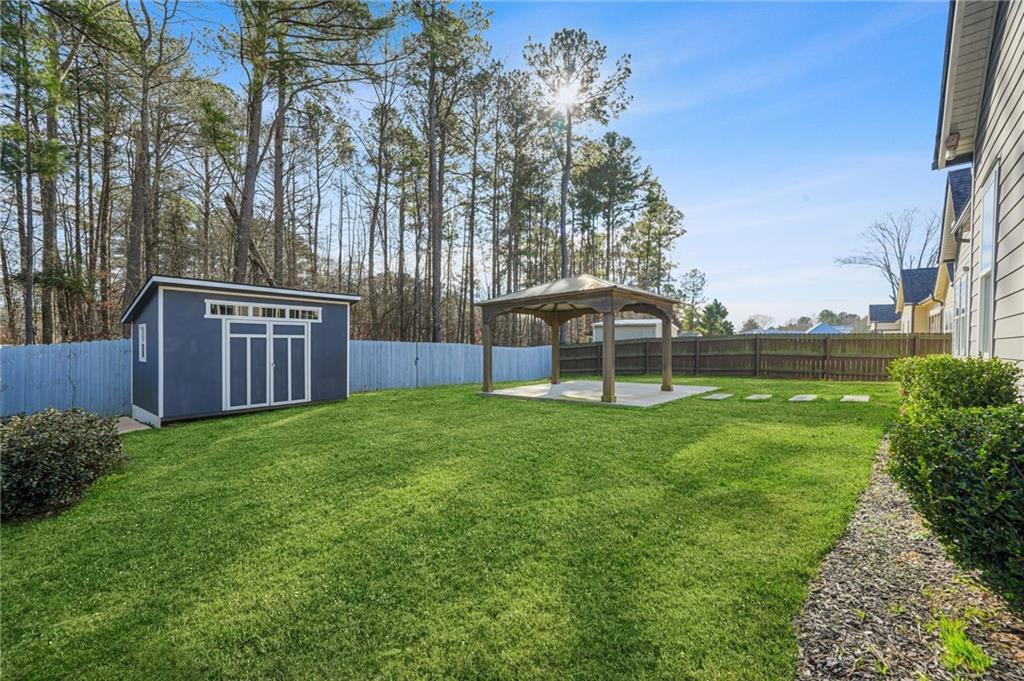 265 Holland Road Powder Springs, GA 30127 - Photo 26 of 27 a view of a backyard with a garden and entertaining space