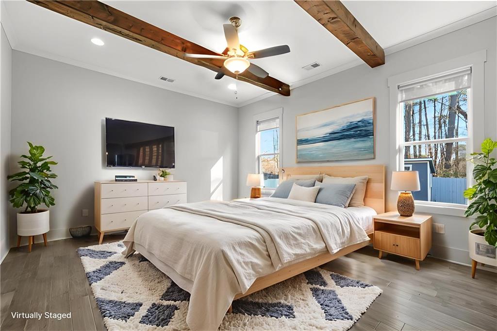 265 Holland Road Powder Springs, GA 30127 - Photo 4 of 27 a bedroom with a bed a flat screen tv and a couch