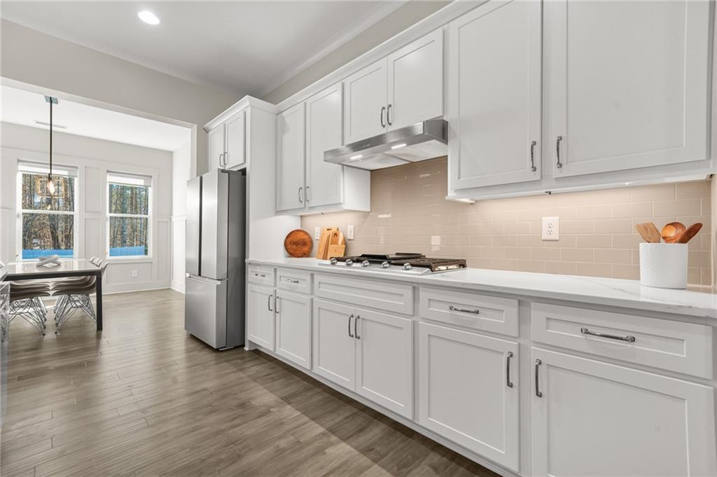 265 Holland Road Powder Springs, GA 30127 - Photo 7 of 27 a kitchen with stainless steel appliances granite countertop a sink a stove and cabinets