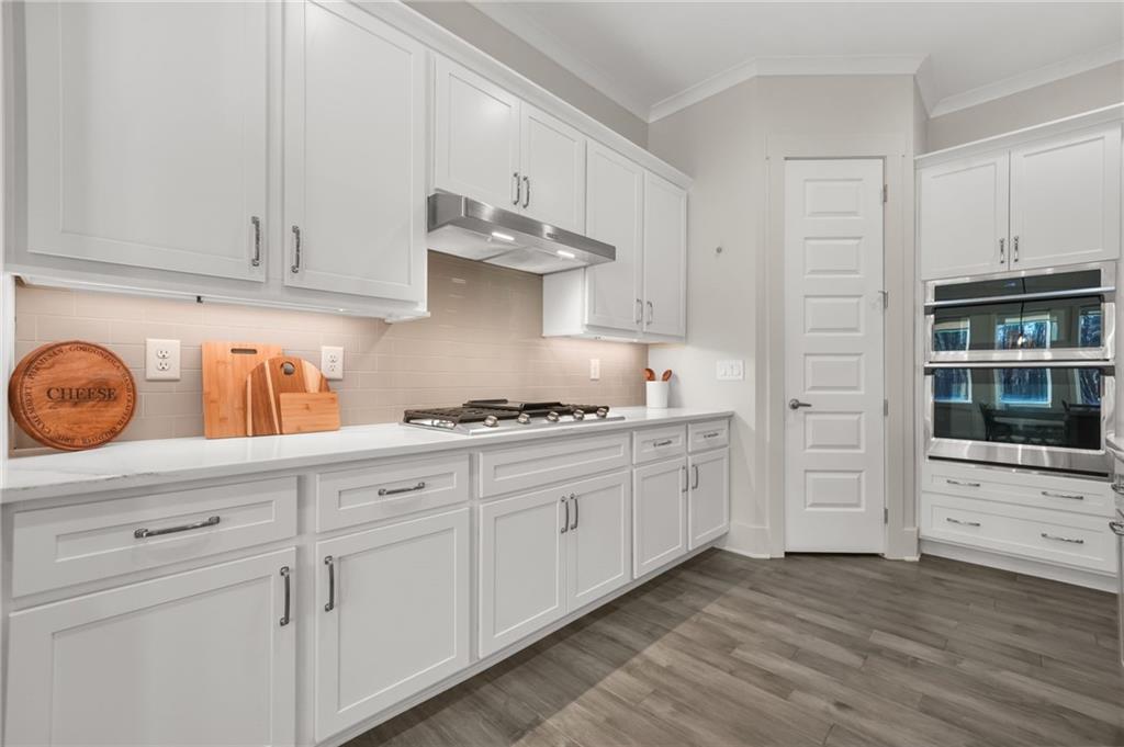 265 Holland Road Powder Springs, GA 30127 - Photo 8 of 27 a kitchen with granite countertop white cabinets and stainless steel appliances