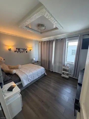 a bedroom with a bed and a mirror