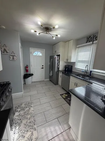 a view of a kitchen with a sink and cabinets