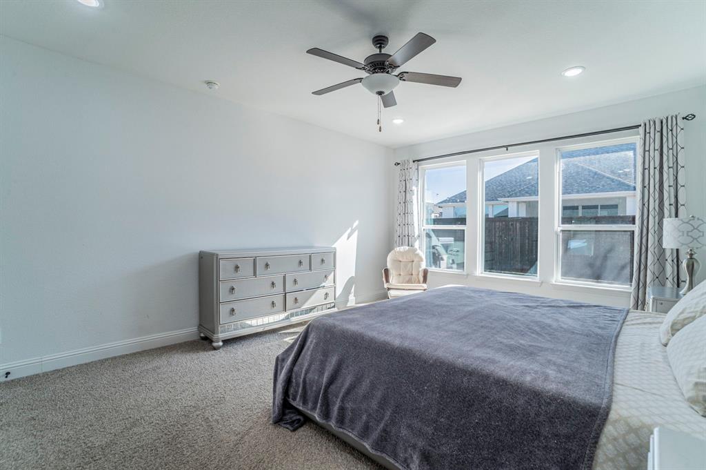 2519 Bedford Road Northlake, TX 76226 - Photo 12 of 33 a spacious bedroom with a large bed and a large window