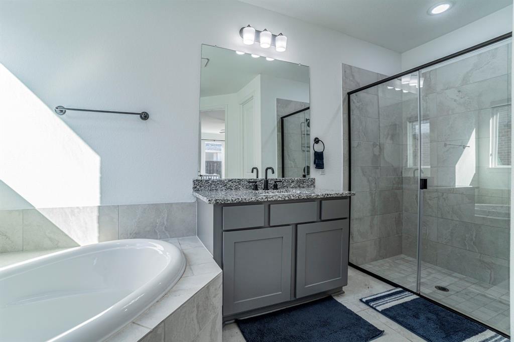 2519 Bedford Road Northlake, TX 76226 - Photo 16 of 33 a bathroom with a bathtub shower sink and mirror
