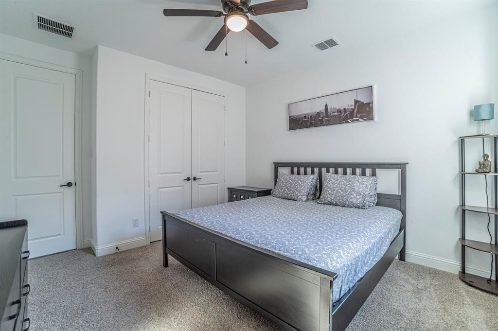 2519 Bedford Road Northlake, TX 76226 - Photo 19 of 33 a bedroom with a bed and ceiling fan