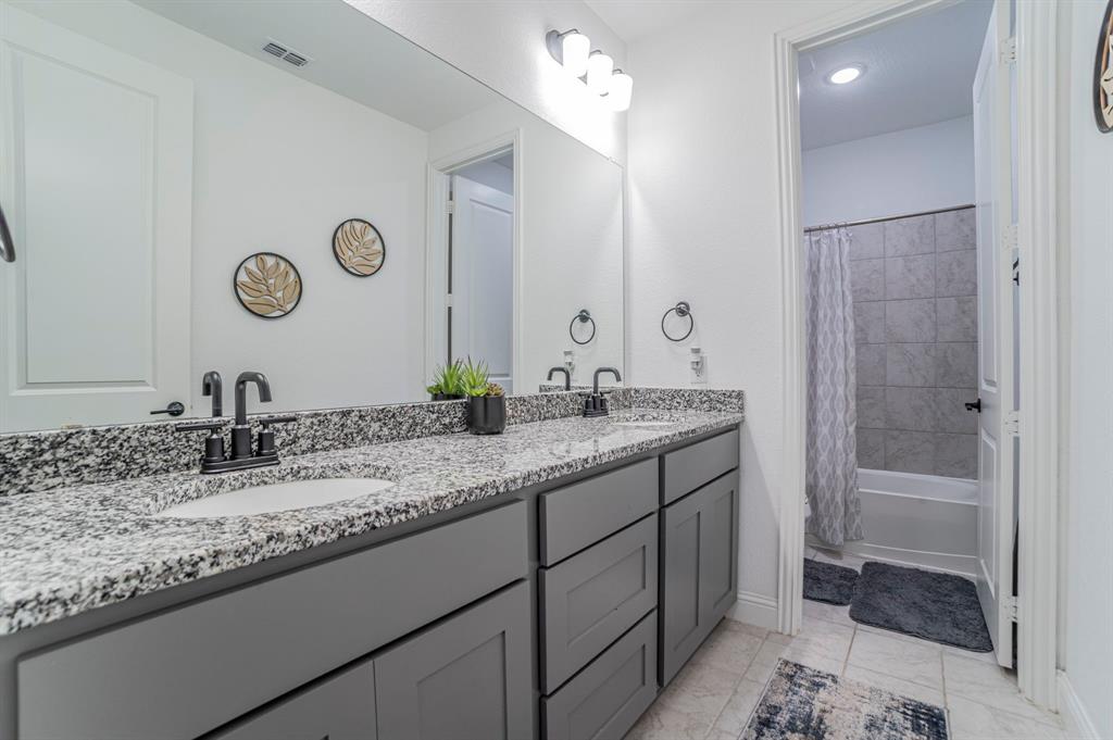 2519 Bedford Road Northlake, TX 76226 - Photo 20 of 33 a bathroom with a granite countertop sink and a mirror