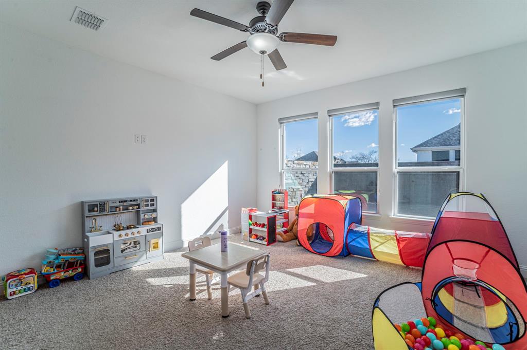 2519 Bedford Road Northlake, TX 76226 - Photo 21 of 33 a living room with furniture and a gym machine