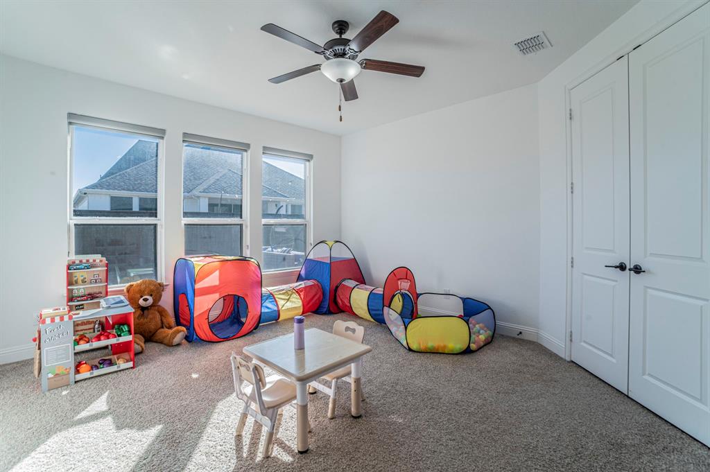 2519 Bedford Road Northlake, TX 76226 - Photo 22 of 33 a room with toys and a chandelier