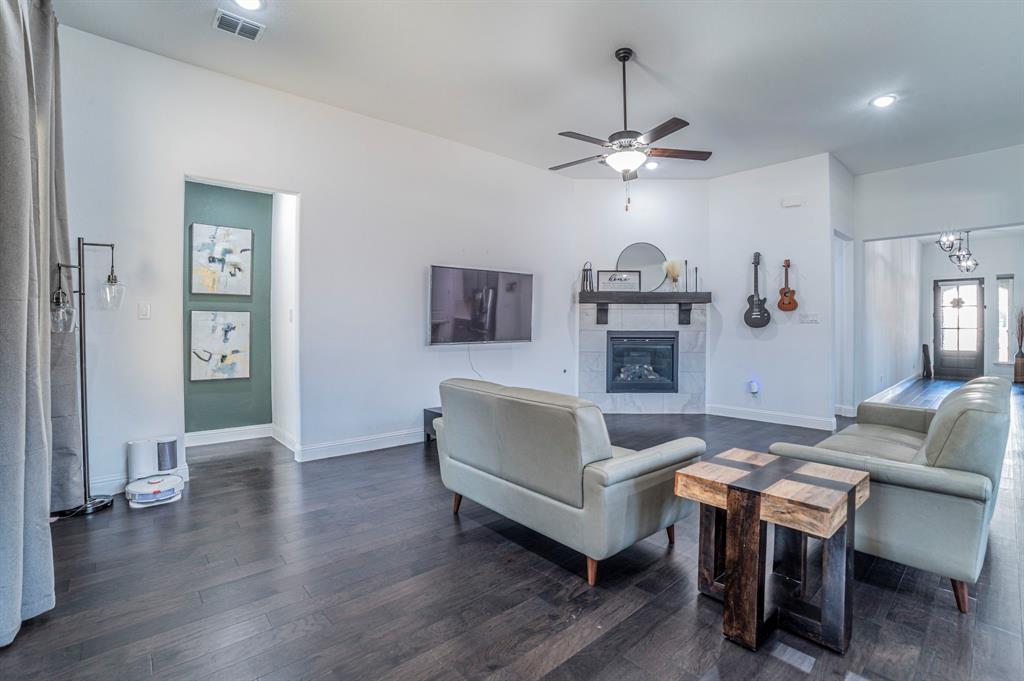 2519 Bedford Road Northlake, TX 76226 - Photo 3 of 33 a living room with furniture a fireplace and wooden floor