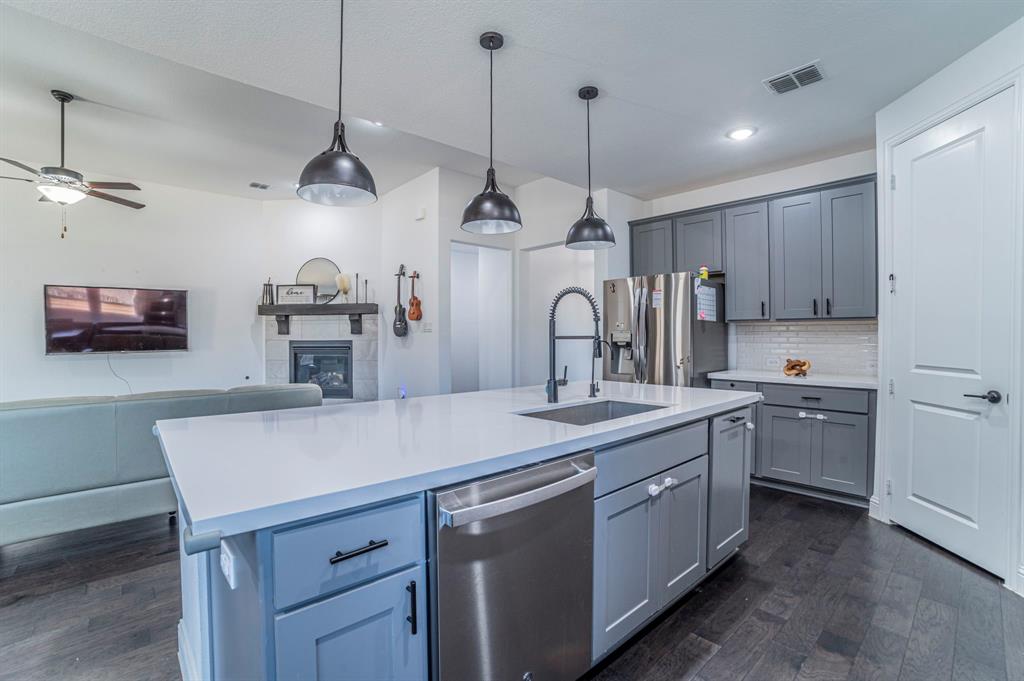 2519 Bedford Road Northlake, TX 76226 - Photo 6 of 33 a kitchen with a sink a counter space appliances and cabinets